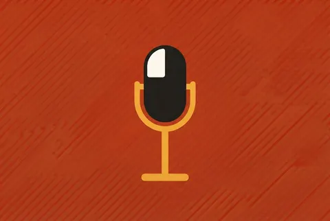 a stage microphone on a red-orange card