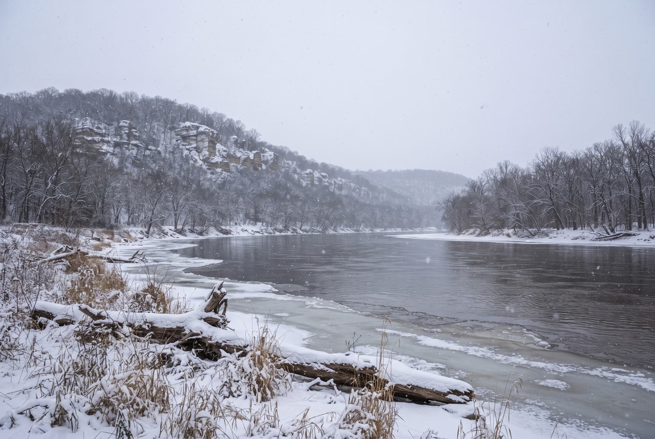 snow on wooded limestone bluffs above the Missouri River in winter